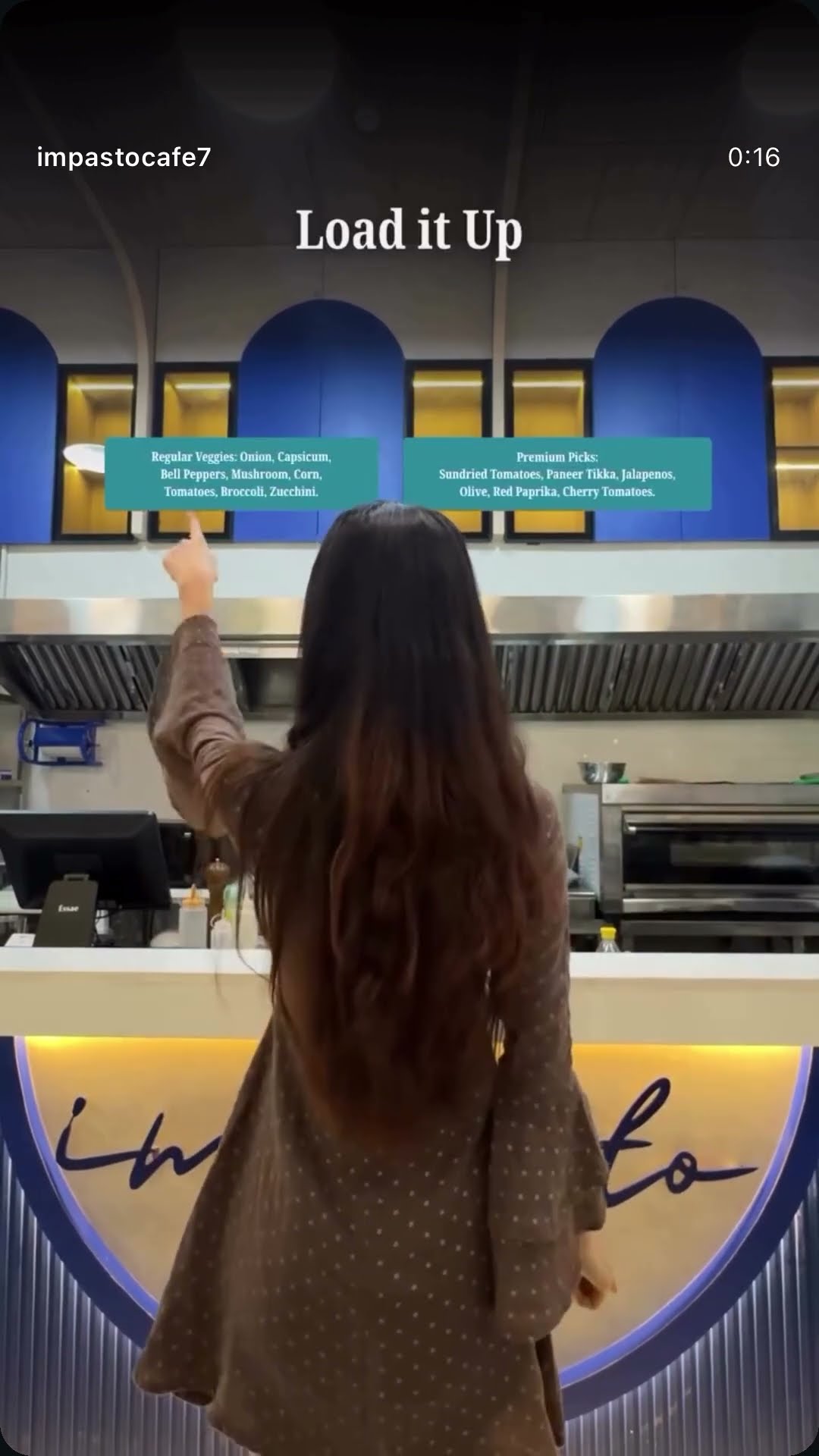A creator at a cafe counter beneath a lit menu board