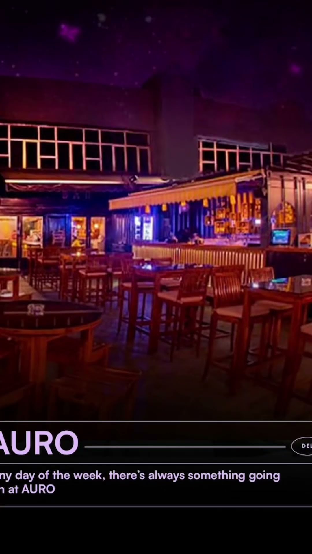 The neon-lit interior of AURO looking across the seating to the bar