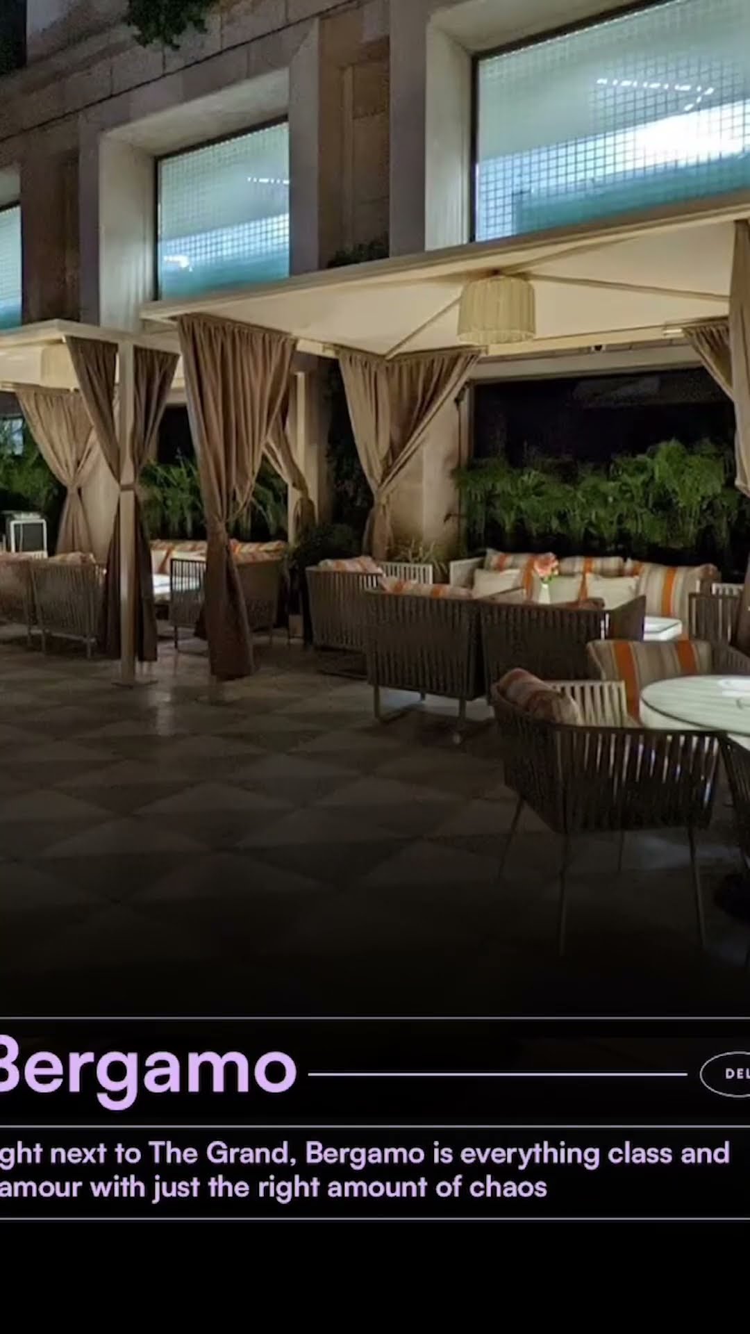 The covered outdoor terrace at Bergamo set for dinner service